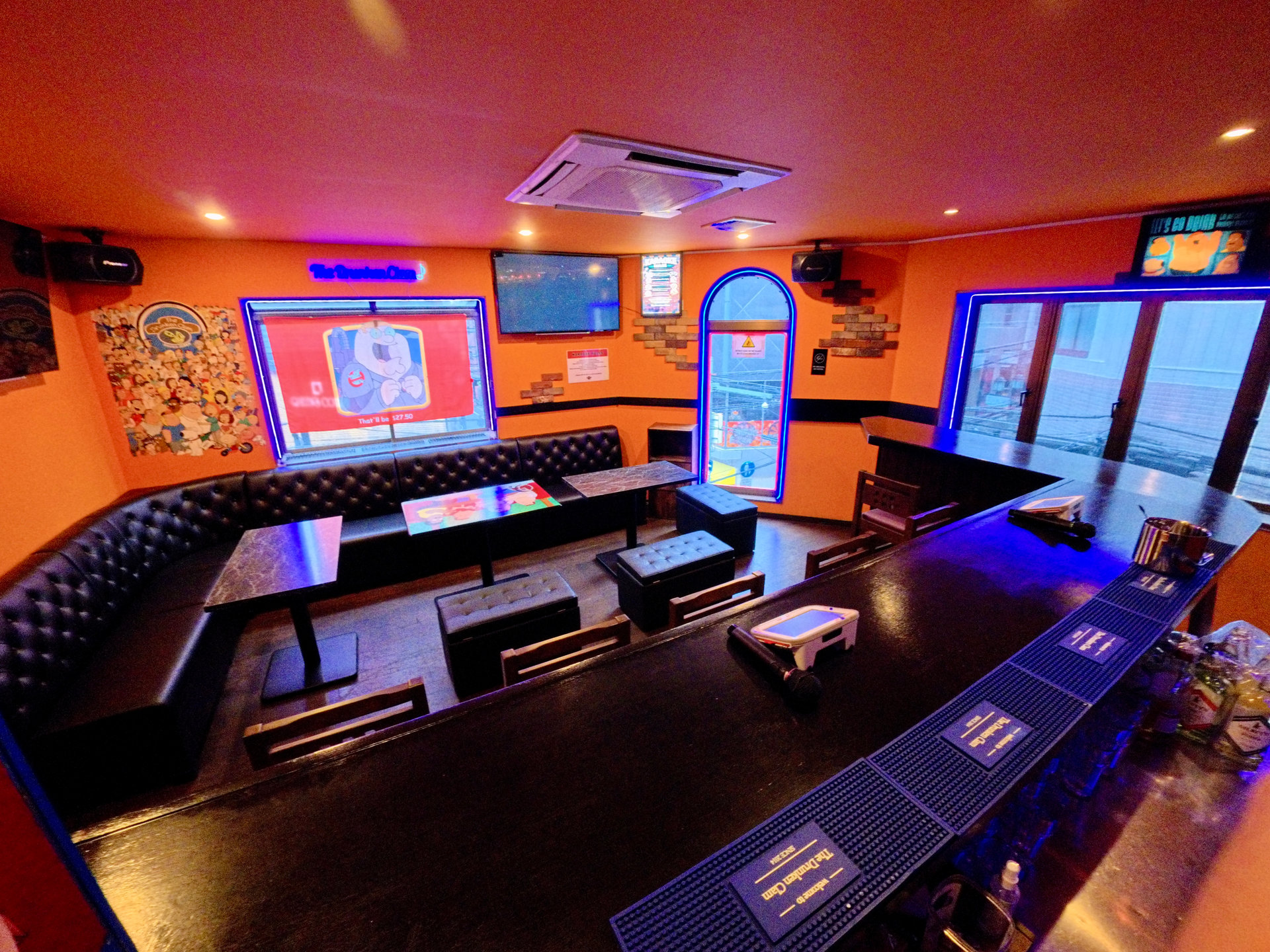Warm orange interior and neon lighting at The Drunken Clam in Osaka
